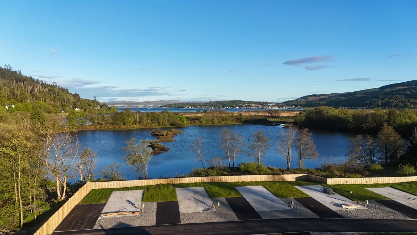 Loch and hills beyond the new pitches on a sunny evening