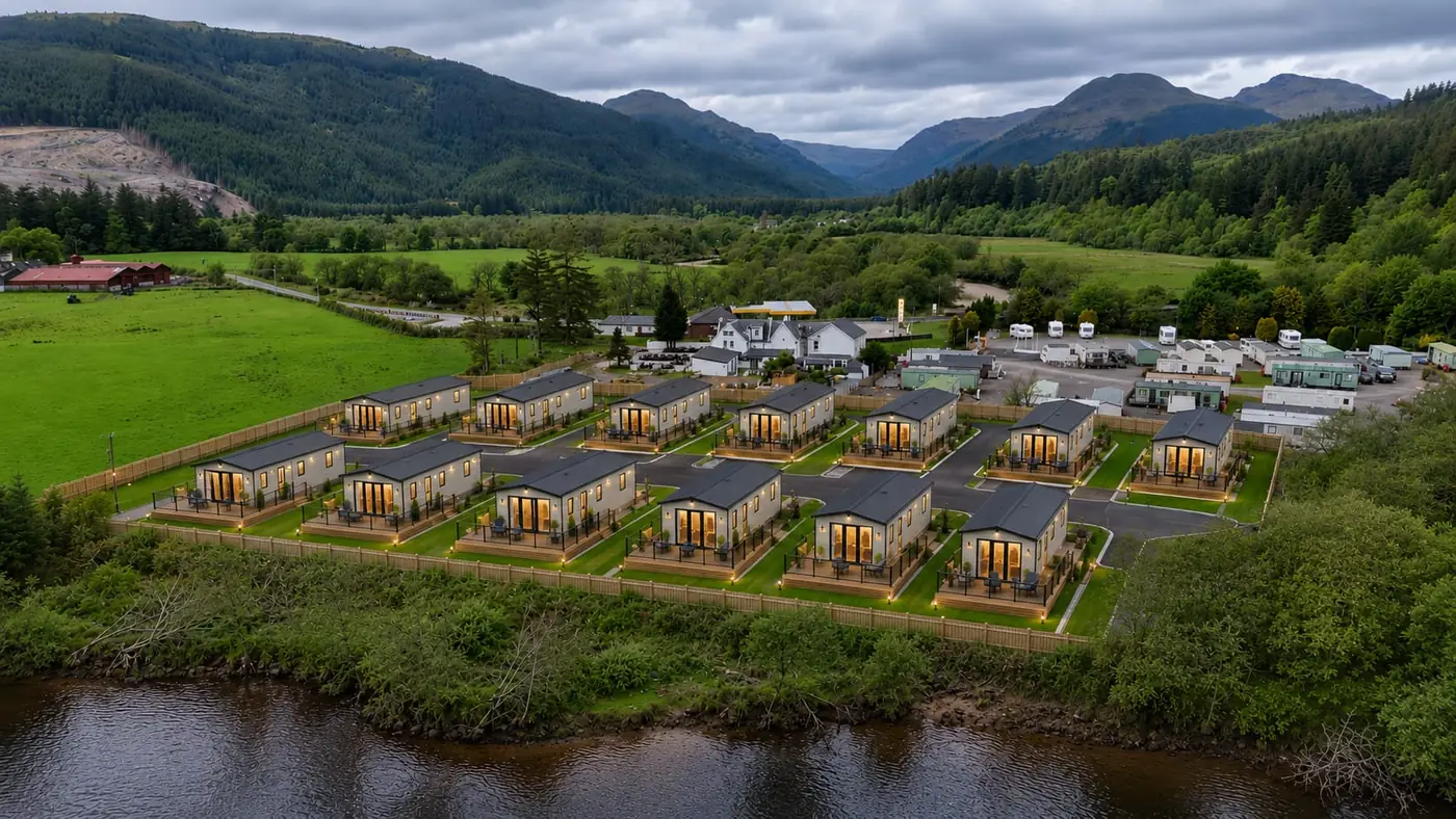 How the finished Cot House holiday home development will look, with lit decking beside the river